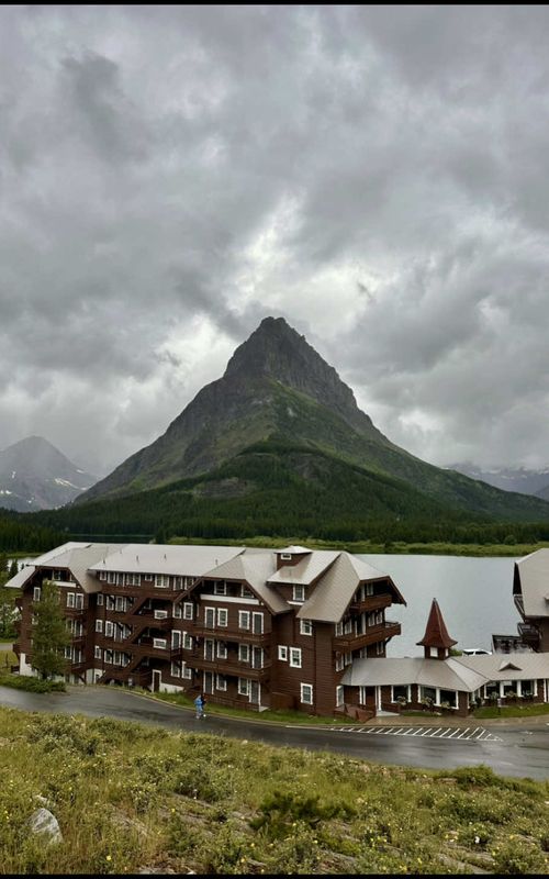 During my visit to Glacier National Park, I was fortunate enough to snag a night at the Many Glacier Hotel — Glacier National Park’s most iconic lodge, built in 1915 with dreamy Swiss chalet vibes. Nestled on Swiftcurrent Lake with jaw-dropping views of Grinnell Point, it’s steps from the park’s best and most famous hikes (Iceberg, Cracker, Grinnell) and full of historic charm. No TV, no distractions…just cozy mountain air, wildlife sightings, and adventure right outside your door. This isn’t just a stay…it’s a time machine into Glacier’s golden era. 🌲🛶  ➡️ From July - September 2025, you cannot access any of the Many Glacier area on a whim by personal vehicle due to construction. Timed entry does not apply to this portion of the park during these dates. Reservations must be made in advance to gain admittance to the road that takes you to the Many Glacier area.  ➡️ The only available reservations to gain access to this area are: a hotel booking (limited availability), boat tour reservation (sold out for weeks in advance), or a hiker shuttle ticket (must be obtained the night prior at 7 pm MST, and are currently selling out within seconds.)  ➡️ You will have to show proof of one of these three reservations at the Many Glacier entrance ranger station to gain access with your personal vehicle at ANY time of the day. There is a locked gate after hours that is only accessible by a unique code that hotel guests are sent a few hours prior to check in that is valid for the duration of their stay.  ➡️ The road to access Many Glacier is an all dirt road up to the last mile or two, filled with heavy dust and potholes and with absolutely zero cell service. Be prepared!  #glaciernationalpark #manyglacierhotel #nationalparks #solotravel #americalodges #hikinglife #montanamagic #travel #traveltok #manyglacier 
