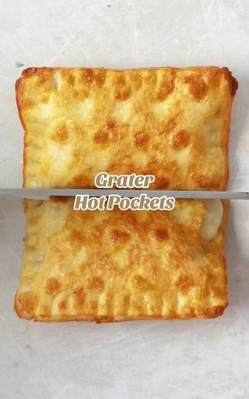 Making ham & cheese hot pockets using a grater. Just press a couple of slices of bread into a grater, then cut into squares using the underside. Fill with ham and cheese and seal the edges with a fork. Brush with egg and toast until crispy and golden. Watch until the end to see what it’s like inside! #hotpockets #homemadehotpockets #foodhack #lunchhack #hamandcheesetoastie