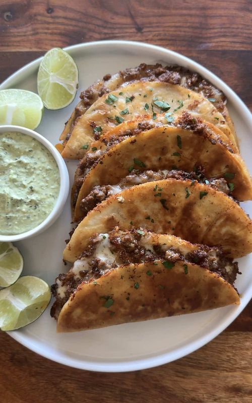 crispy beef tacos 🌮  - cheesy ground beef tacos with a crispy tortilla shell served with homemade cilantro lime sauce  🔗 full recipe is on my website link in bio 💗 #beef #tacos #Recipes #Foodtok