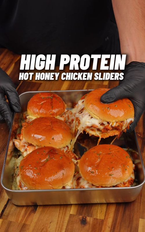 High Protein Hot Honey Chicken Sliders! 🔥🍯🍔#hothoneychickensliders #sliders #lowcalorie 56g Protein! ONLY 560 calories, easy high protein meal 💪🏽 Checkout my High Protein Cookbook with 300+ recipes just like this one & calorie tracking barcodes (Link in bio!)📕👨🏽‍🍳  Calories & Macros 📊 Per Bun: 560 calories 56g | 33g | 21g F   For the hot honey chicken  - 800g chicken breast - 1 tbsp paprika - 1 tbsp onion powder - 1 tbsp garlic powder - 1 tsp cayenne pepper - 2 tsp black pepper - 1 tbsp salt - Cooking spray (roughly 1 tbsp oil in total) - 1/2 red onion - 2 tbsp sweetcorn - 90g low fat cheese (I used 50% less fat cheddar) - 2 tsp oregano - 60ml hot sauce (I used franks red hot) - Drizzle of honey Sriracha mayo - 2 tbsp light mayo - 1 tbsp sriracha - 1 tsp honey Other ingredients - 6 aldi brioche burger buns - 100g low fat Swiss cheese (I used leerdamer 50% less fat - sub with low fat cheddar) - Sliced pickles - 250g mozzarella (use reduced fat is you have it - divided between 6 burgers) Garlic butter (optional) - 1 tbsp light butter - 1/2 tsp garlic paste - parsley flakes Oven bake at 190°C / 375°F | 10-12 minutes 🔥 Storage & Heating ♨️ - if storing, wrap in foil once cooled and store in the fridge, to reheat microwave for 30 seconds to a minute to remove the chill then air fry to get toasty again Checkout my High Protein Cookbook with 300+ recipes just like this one & calorie tracking barcodes (Link in bio!)📕👨🏽‍🍳 