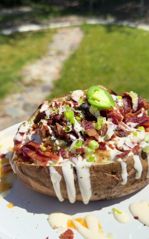 bacon jalapeno popper baked potato , i win 🫶🏼  bake 4-5 strips of bacon, drain grease and set aside  bake russet potato for 40 mins then take out and rub with olive oil, bake for another 30 mins  cut stems off of jalaleno and remove seeds and pith with a paring knife in a bowl combine cream cheese, shredded colby jack, garlic powder, paprika, and a little cayenne. mix well (my cream cheese fell out a little so i would make sure the bacon is covering the top so that doesn’t happen as much) add cream chese filling to jalapenos and wrap 1 strip of bacon around tightly, air fry for 15 mins or until bacon is fully cooked  to assemble, open potato and fluff insides with a spoon or fork, add butter and season to your preference (i also added the leftover cream cheese) top with jalapeno popper, bacon, sour cream and green onions. enjoy! #bakedpotato #DinnerIdeas #dinner #cooking #recipeideas 
