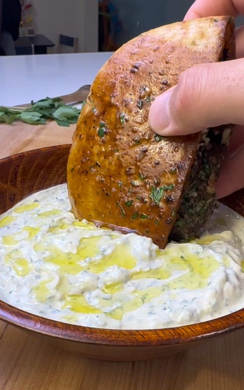 Arayes 🥙 This is one of the best Mediterranean meals you can easily make at home in about 30 minutes. Crispy pita stuffed with seasoned beef, cooked until golden, and finished with a creamy garlic sauce. If you’re always looking for new dinner ideas, you’re in the right place. That’s why I share simple and affordable meals that save you time and money. Follow for more weeknight staples. Ingredients Meat Mixture • 1 lb ground beef (85/15) • 1 small yellow onion, grated and squeezed dry • 5 garlic cloves, finely grated • 1 grated jalapeño • 2 tbsp tomato paste • ⅓ cup parsley, finely chopped • ¼ cup cilantro, finely chopped • 1 tbsp olive oil • 1 tbsp ice water • 1 tsp salt • 1 tsp black pepper • 2 tsp cumin • 2 tsp paprika • 1 tsp allspice • 1 tsp coriander • 1 tsp garlic powder • ¼ tsp cinnamon Other • 4 pitas, cut in half Garlic Tahini Yogurt Sauce • ¾ cup Greek yogurt • ¼ cup tahini • 3 garlic cloves, finely grated • Juice of ½ lemon • 1 tbsp olive oil • ½ tsp salt • ¼ tsp cumin • 2 tbsp parsley, finely chopped • 2 tbsp cilantro, finely chopped Instructions 1. Preheat oven to 350°F. 2. In a large bowl, mix together the beef, grated onion, garlic, jalapeño, tomato paste, parsley, cilantro, olive oil, ice water, and spices until fully combined and slightly sticky. 3. Cut the pitas in half and gently open each pocket (heat the pitas in the microwave for a few seconds first to make them easier to open). Spread a thin layer of the meat mixture inside each pita, then brush the outside generously with olive oil. 4. Heat a pan over medium heat. Cook the arayes meat side down first for 1–2 minutes until charred, then flip and cook each pita side until golden and crispy. 5. Finish in the oven for 15 minutes, or until the meat reaches 155°F internally. 6. While the arayes cook, mix together all sauce ingredients until smooth. 7. Brush the hot arayes with olive oil mixed with minced garlic and parsley, then serve with the dipping sauce. #easydinners #arayes #pita 