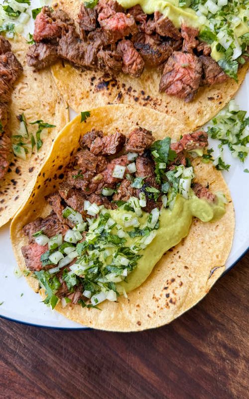 Steak Tacos with Avocado Salsa… easy, delicious & absolutely bursting with flavour. The tacos are loaded with juicy, marinated, cooked-to-perfection steak topped with a fresh, creamy, tangy & slightly spicy avocado salsa. I used flap steak here (highly underrated in my opinion) but you can sub skirt, flank or ribeye. The marinade is also amazing on chicken. For the salsa, if you like it spicy, add more jalapeño or serrano. If you want it mild, remove the seeds or just omit the chiles altogether. Serve on your favourite warmed tortillas, top with some fresh cilantro + onion & serve with some charred green onion . Find the full recipe on my Substack (link in my bio) #fypシ゚ #tacos #salsa #cincodemayo #healthyrecipes 
